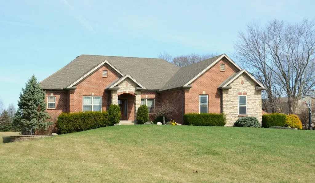 Brick ranch-style home with a landscaped front lawn